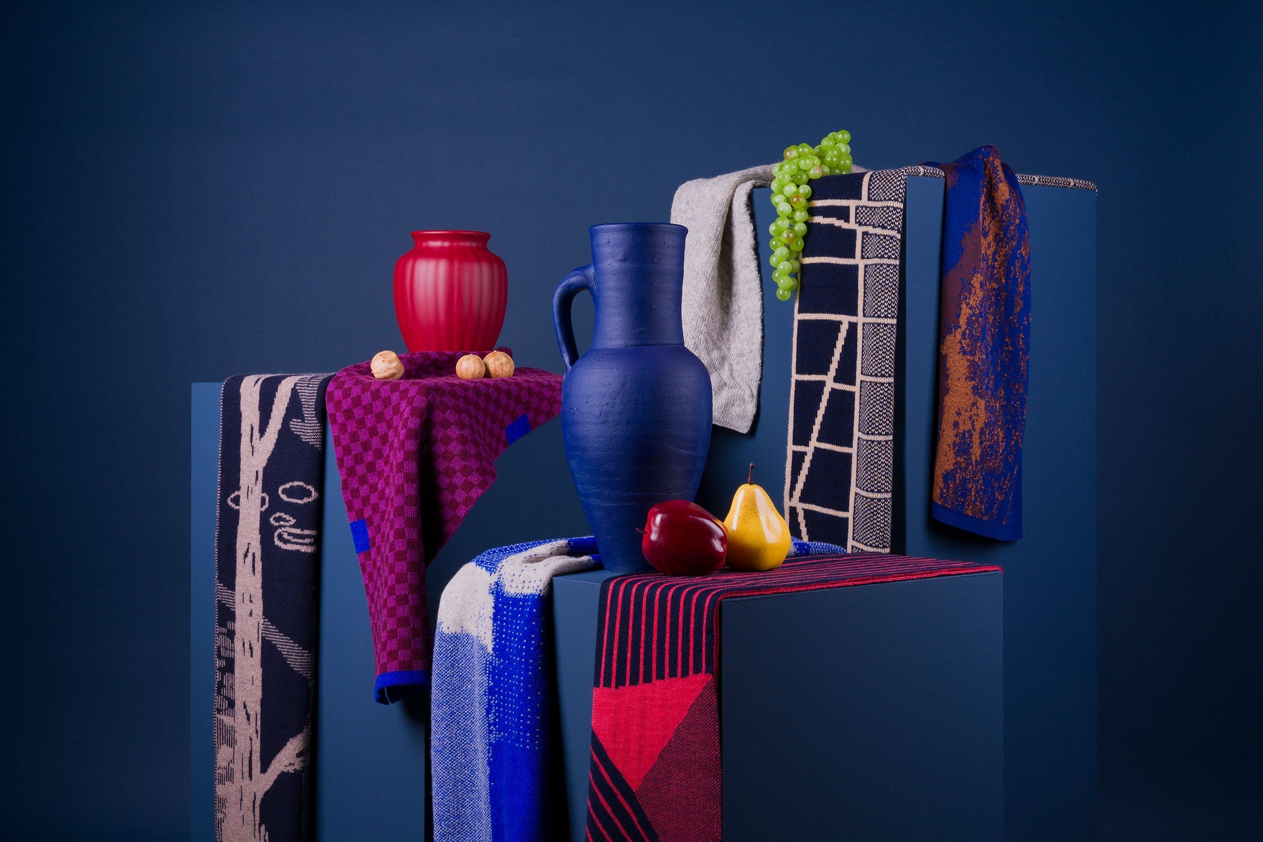 Young lady with blue and beige Myosotis 05 scarf draped over her shoulder.